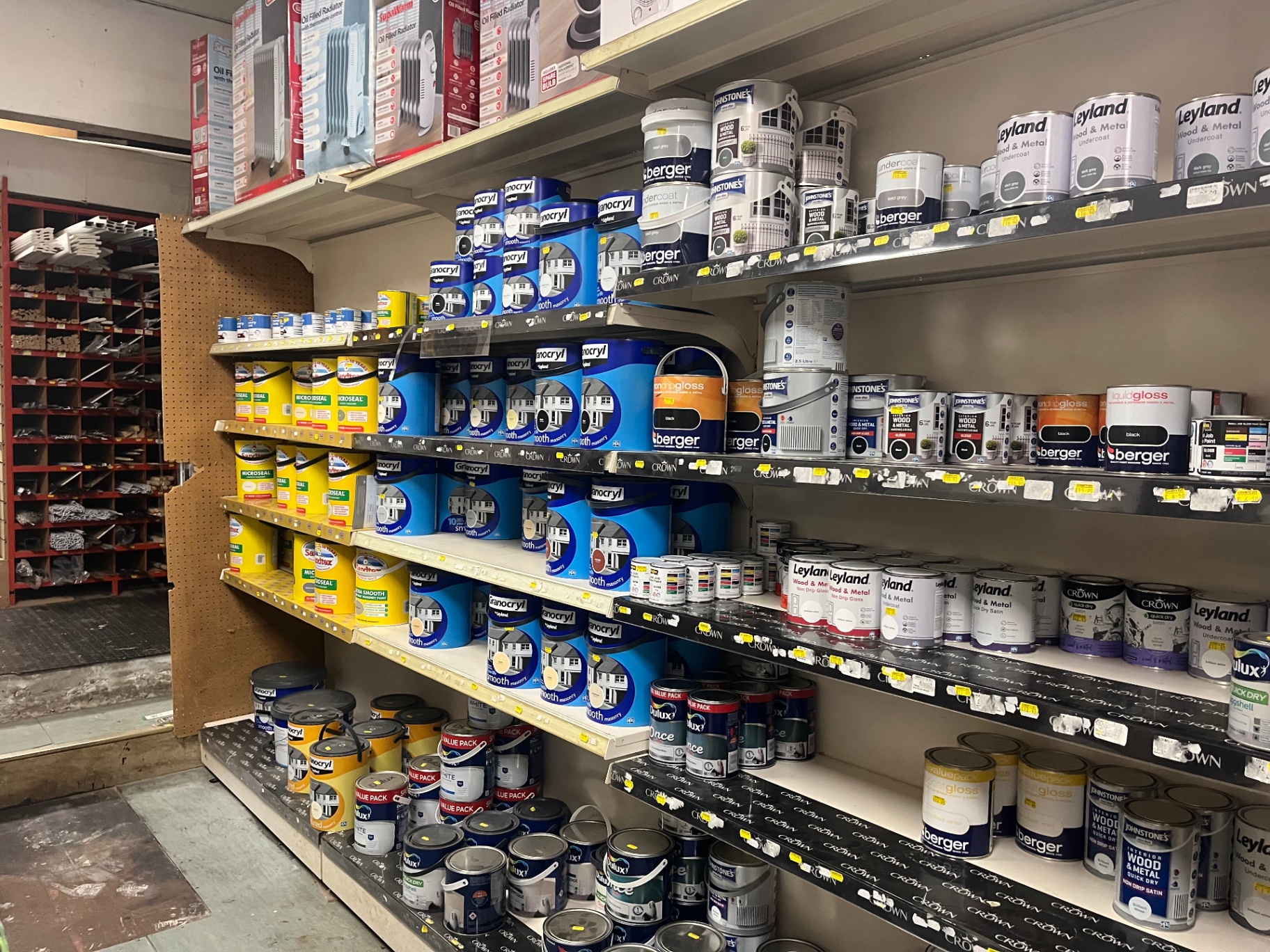 County DIY paint shelves stocked with tins of paint and decorating products